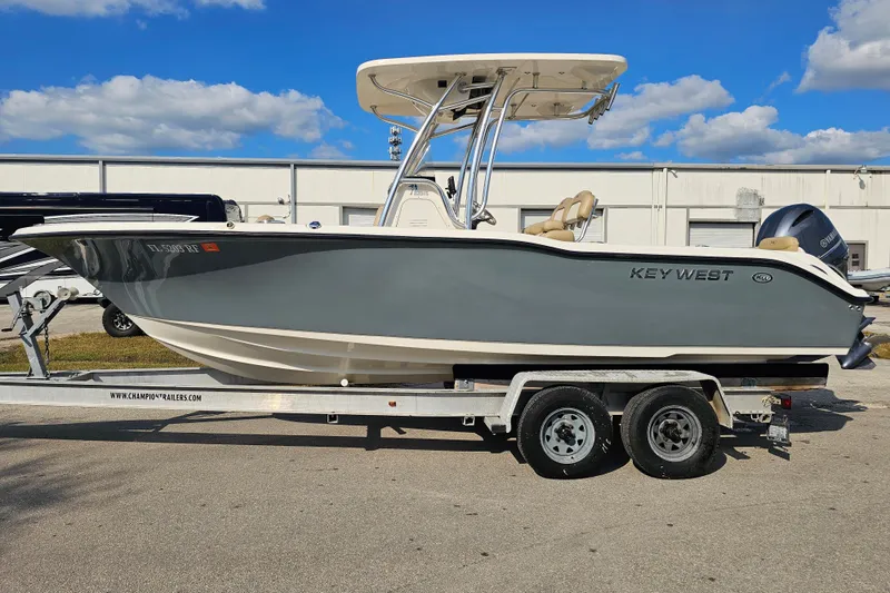 Slide: The Image of 2017 Key West 239 FS boat on trailer under blue sky. - 2