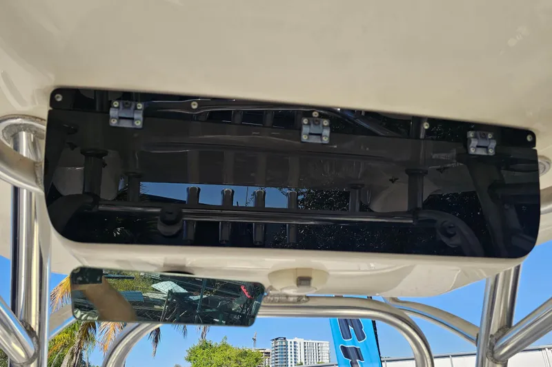 Slide: The Image of 2017 Key West 239 FS boat console with rod holders and mirror, outdoor setting. - 23