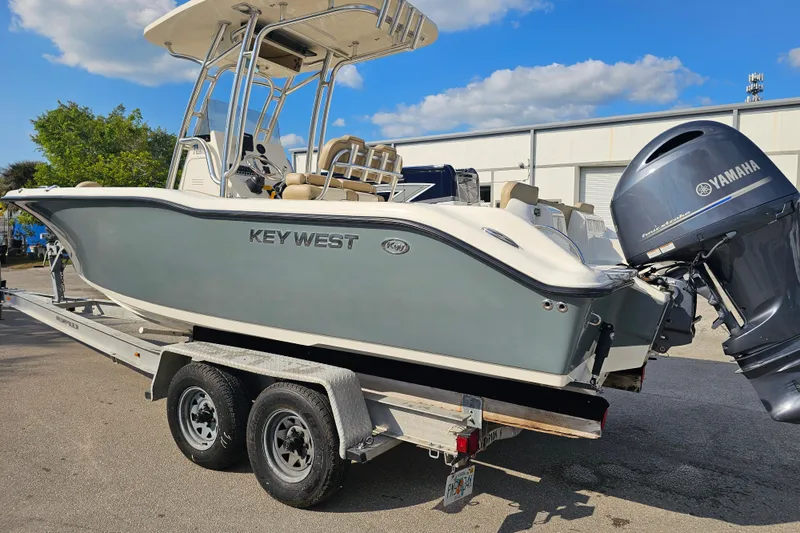 Slide: The Image of 2017 Key West 239 FS boat on trailer with Yamaha outboard motor, parked outdoors. - 3