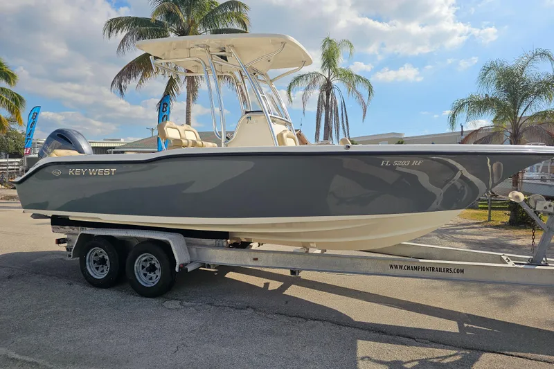 Slide: The Image of 2017 Key West 239 FS boat on trailer, palm trees in background. - 7