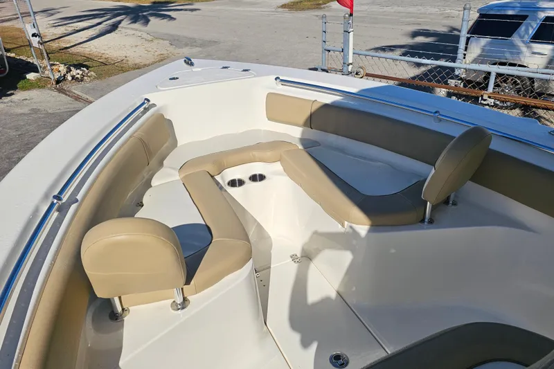 Slide: The Image of 2017 Key West 239 FS boat interior with beige seating and cup holders. - 8