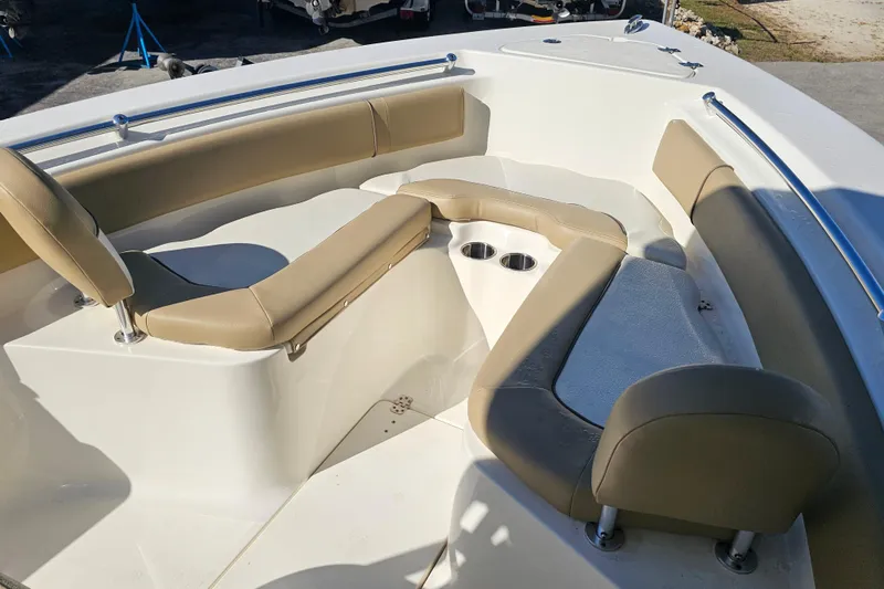 Slide: The Image of 2017 Key West 239 FS boat interior with beige seating and cup holders. - 9
