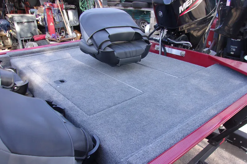 Slide: The Image of 2024 Bass Tracker Classic XL boat interior with carpeted deck and seating. - 10