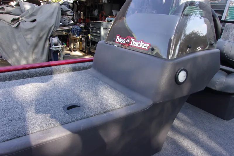 Slide: The Image of 2024 Bass Tracker Classic XL boat interior with carpeted deck and console. - 12