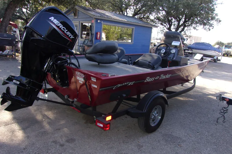 Slide: The Image of 2024 Bass Tracker Classic XL boat with Mercury engine, parked on a trailer. - 3
