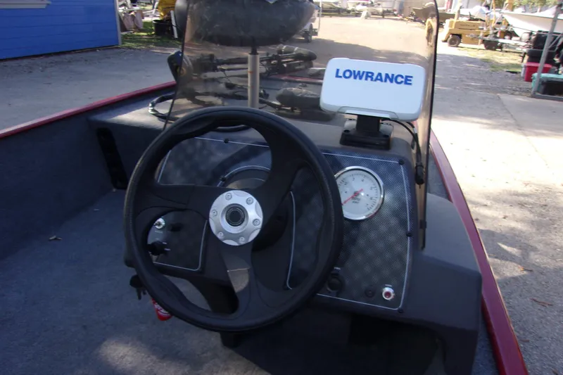 Slide: The Image of 2024 Bass Tracker Classic XL boat dashboard with steering wheel and Lowrance device. - 5