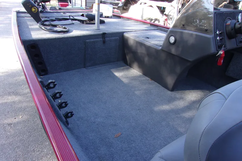 Slide: The Image of 2024 Bass Tracker Classic XL boat interior with carpeted deck and steering console. - 9