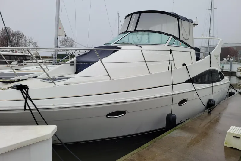 Slide: The Image of 2006 Carver 36 Mariner helm with steering wheel, gauges, and navigation display. - 3
