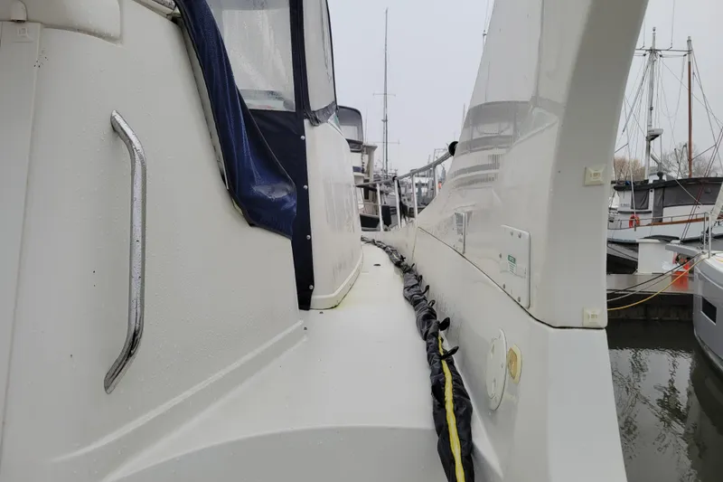 Slide: The Image of 2006 Carver 36 Mariner yacht docked at a marina, featuring sleek design and spacious cabin. - 9