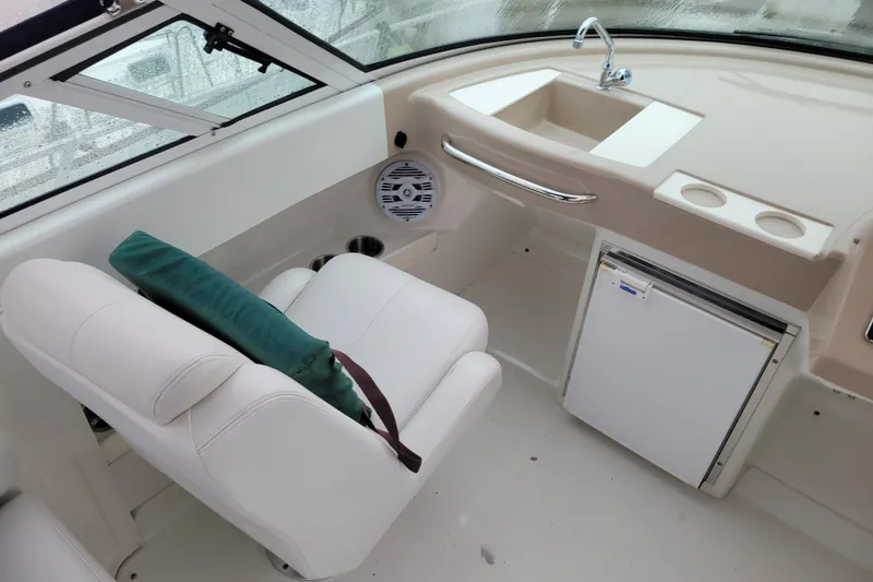 Slide: The Image of 2006 Carver 36 Mariner yacht docked, showcasing sleek white exterior and marina setting. - 15