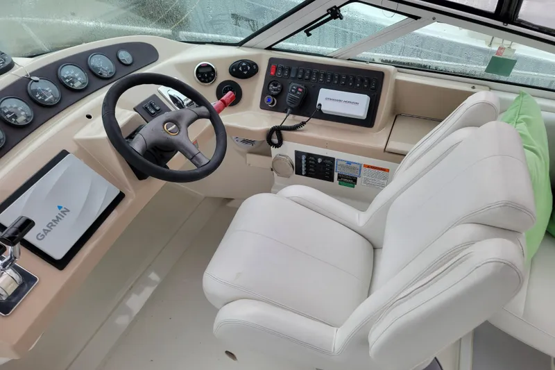 Slide: The Image of 2006 Carver 36 Mariner yacht docked, showcasing sleek white exterior and blue canopy. - 16