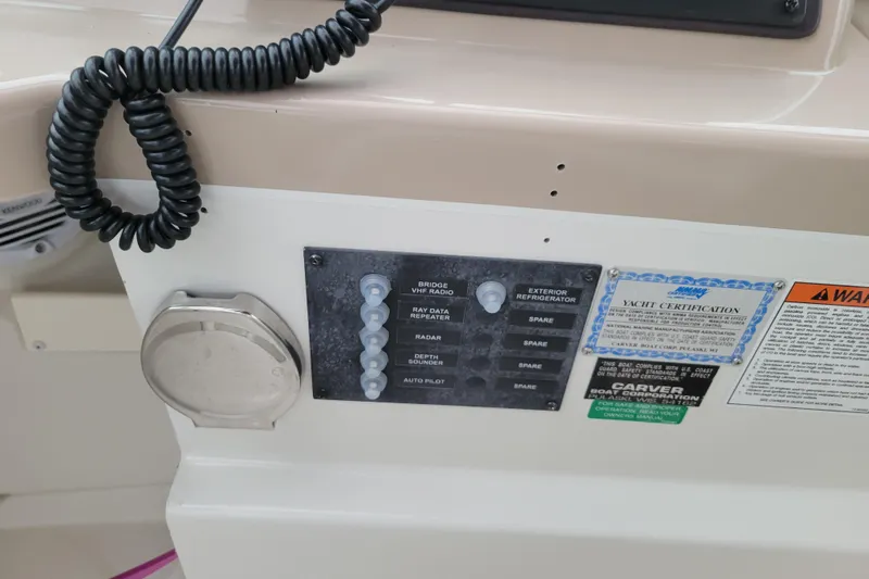 Slide: The Image of White seat on 2006 Carver 36 Mariner boat with green cushion and cup holders. - 21