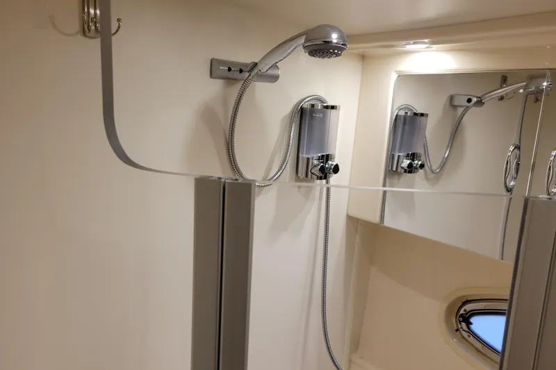 Slide: The Image of Control panel of a 2006 Carver 36 Mariner boat with steering wheel and throttle levers. - 30