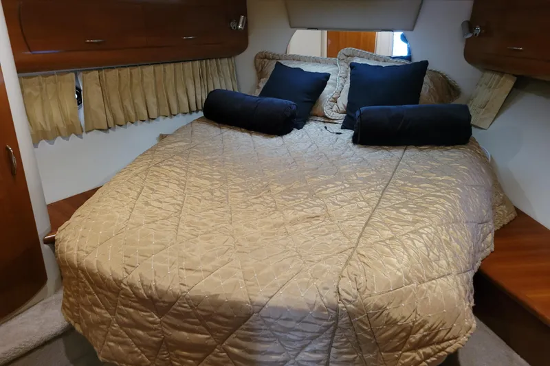 Slide: The Image of Luxurious interior of 2006 Carver 36 Mariner yacht with beige seating and wooden cabinetry. - 33