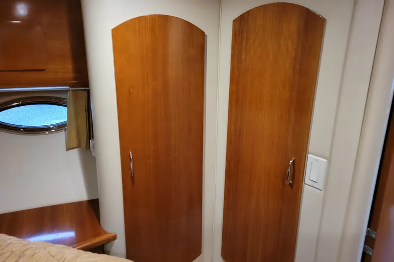 Slide: The Image of Luxurious beige sofa with yellow and black cushions in a 2006 Carver 36 Mariner yacht. - 34