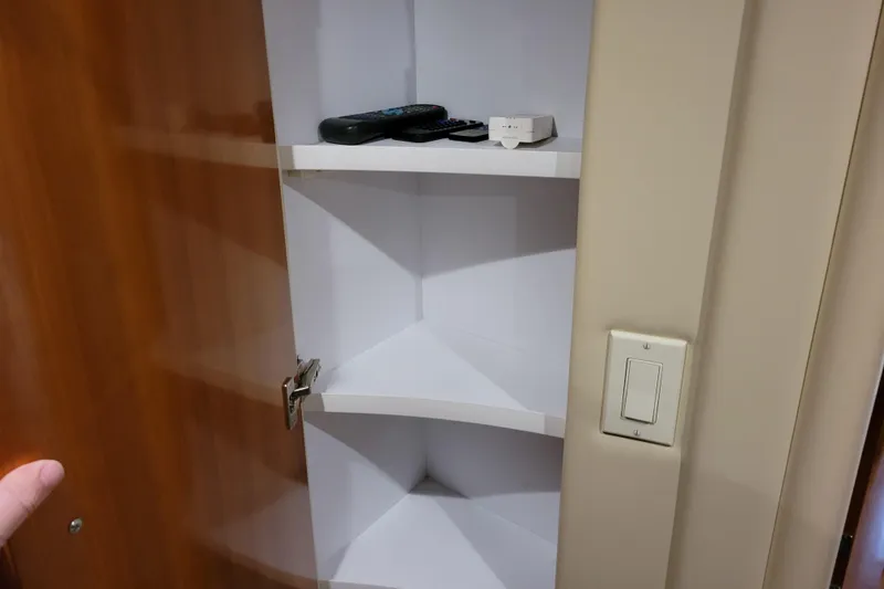 Slide: The Image of 2006 Carver 36 Mariner kitchen with wood cabinetry, sink, microwave, and stovetop. - 37