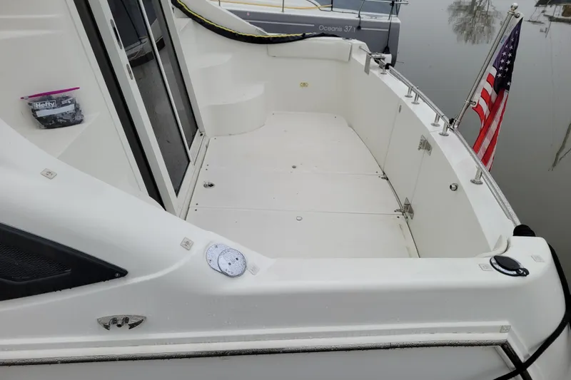 Slide: The Image of 2006 Carver 36 Mariner yacht docked at marina, featuring sleek design and spacious deck. - 4