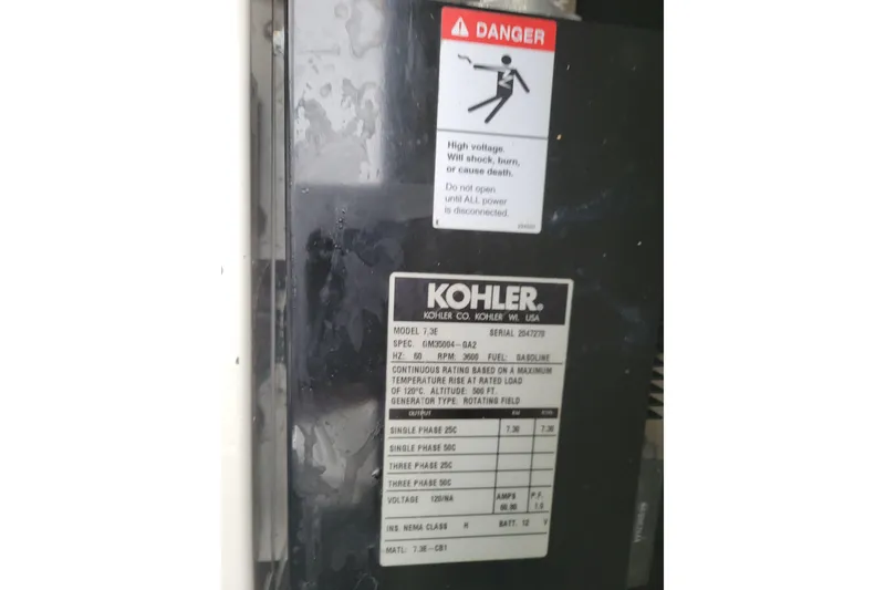 Slide: The Image of Kohler generator label on 2006 Carver 36 Mariner, warning of high voltage danger. - 67
