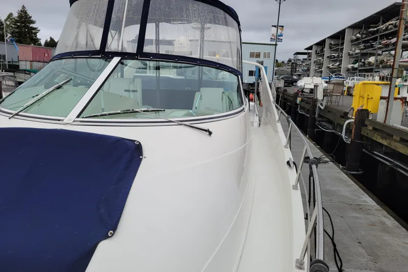 Slide: The Image of 2006 Carver 36 Mariner docked at marina, featuring sleek design and spacious deck. - 74