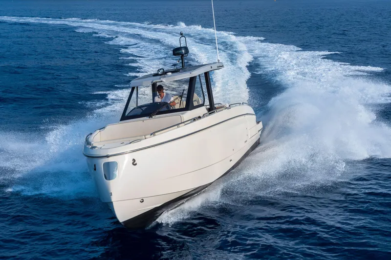 Slide: The Image of 2025 Beneteau Gran Turismo 35 cruising on open water, creating a dynamic wake. - 10