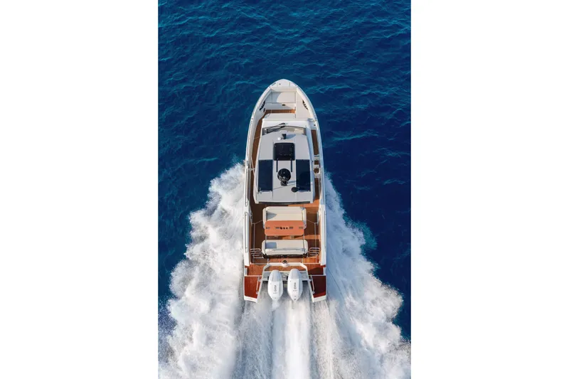 Slide: The Image of 2025 Beneteau Gran Turismo 35 yacht cruising on open blue sea, aerial view. - 12
