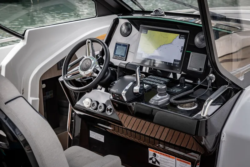 Slide: The Image of 2025 Beneteau Gran Turismo 35 cockpit with advanced navigation system and sleek steering wheel. - 15