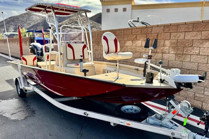 Slide: The Image of 2021 G3 Bay 20 DLX boat on trailer, red and white design, parked outdoors. - 1