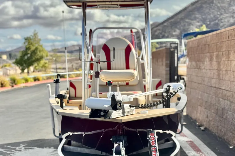 Slide: The Image of 2021 G3 Bay 20 DLX boat with Minn Kota motor, parked outdoors. - 2