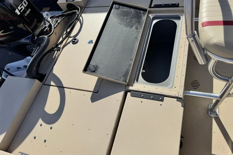 Slide: The Image of 2021 G3 Bay 20 DLX boat deck with open storage compartment and Yamaha 150 engine. - 20