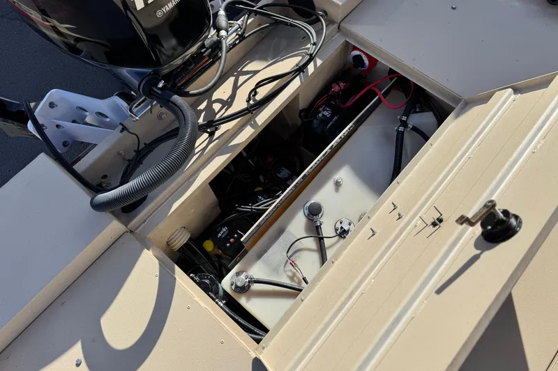 Slide: The Image of 2021 G3 Bay 20 DLX boat engine compartment with Yamaha motor and wiring. - 21