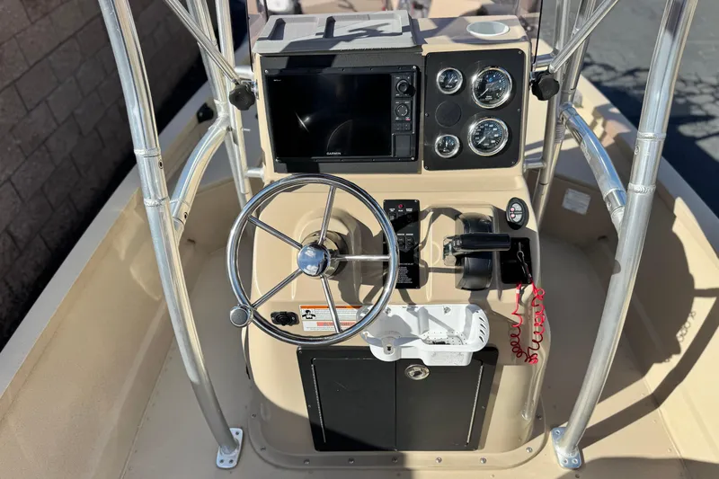 Slide: The Image of 2021 G3 Bay 20 DLX boat console with steering wheel, gauges, and navigation system. - 23