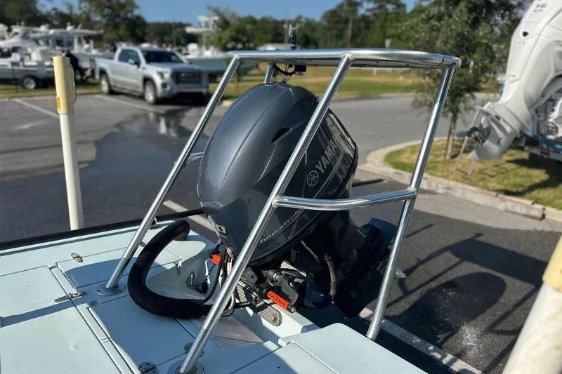 Slide: The Image of 1986 Dolphin 16 SUPER SKIFF with Yamaha outboard motor in a parking lot. - 10