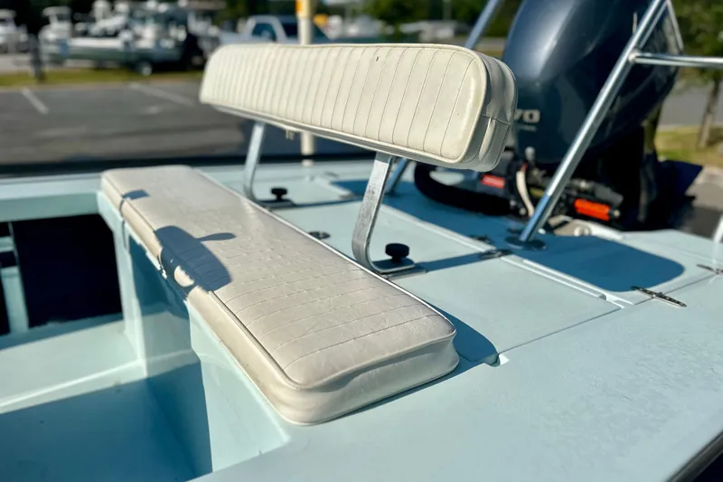 Slide: The Image of 1986 Dolphin 16 SUPER SKIFF boat with white seating and outboard motor. - 11