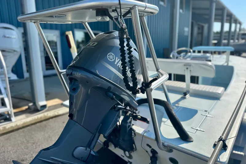 Slide: The Image of 1986 Dolphin 16 SUPER SKIFF with Yamaha outboard motor, docked at marina. - 4