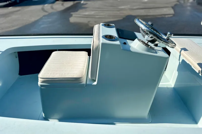 Slide: The Image of 1986 Dolphin 16 SUPER SKIFF boat interior with steering wheel and cushioned seat. - 7