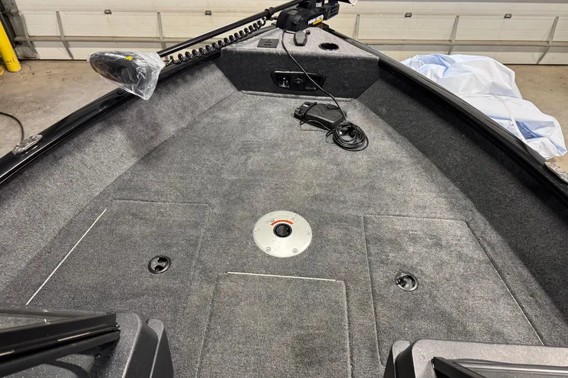 Slide: The Image of 2026 Tracker Pro Guide V-175 WT boat interior with carpeted deck and mounted equipment. - 18