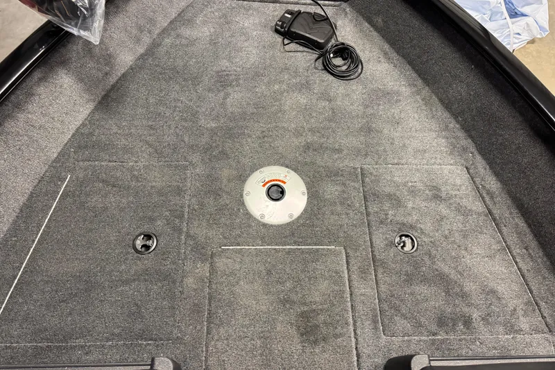 Slide: The Image of 2026 Tracker Pro Guide V-175 WT boat interior with carpeted deck and storage compartments. - 19