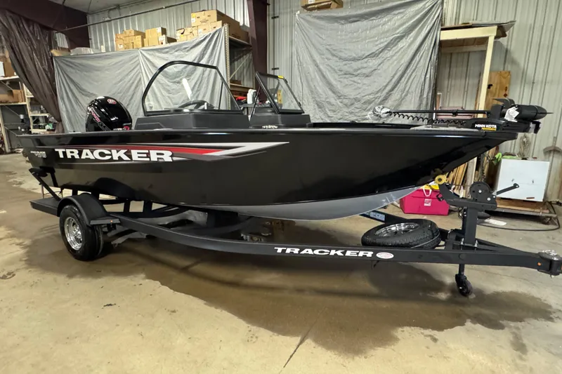 Slide: The Image of 2026 Tracker Pro Guide V-175 WT boat on trailer in a warehouse setting. - 2