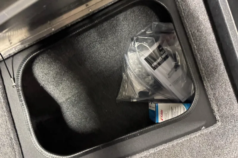 Slide: The Image of Storage compartment in 2026 Tracker Pro Guide V-175 WT boat with manuals and items. - 22