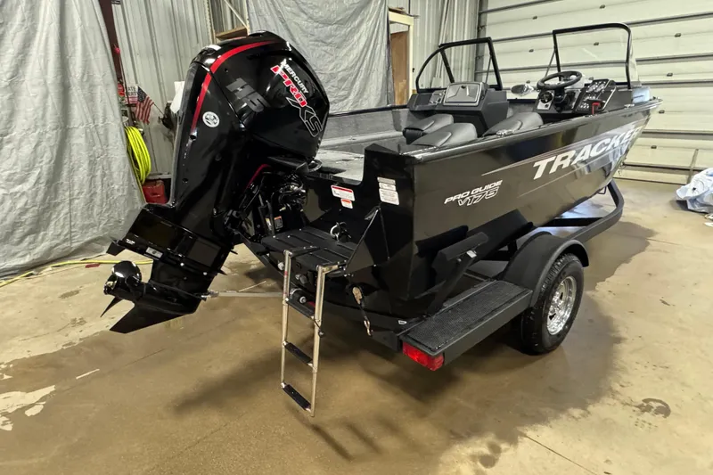 Slide: The Image of 2026 Tracker Pro Guide V-175 WT boat with powerful outboard motor in a garage setting. - 3