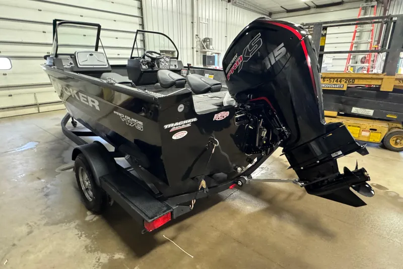 Slide: The Image of 2026 Tracker Pro Guide V-175 WT boat with powerful engine in a garage setting. - 4