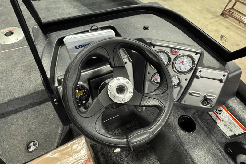 Slide: The Image of 2026 Tracker Pro Guide V-175 WT boat dashboard with steering wheel and gauges. - 7