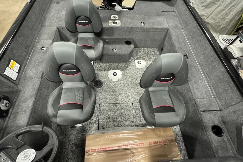 Slide: The Image of 2026 Tracker Pro Guide V-175 WT boat interior with four gray seats and steering wheel. - 8