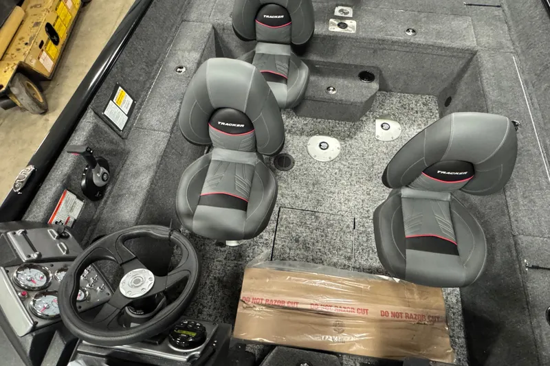 Slide: The Image of 2026 Tracker Pro Guide V-175 WT boat interior with gray seats and steering wheel. - 9