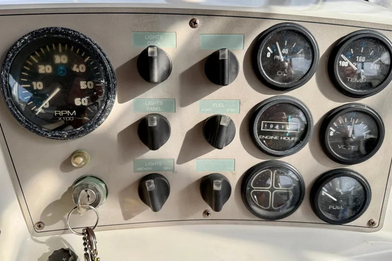 Slide: The Image of Dashboard of a 1997 Carver 355 Aft Cabin Motor Yacht with gauges and controls. - 15