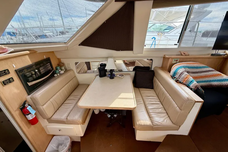 Slide: The Image of 1997 Carver 355 Aft Cabin Motor Yacht interior with cozy seating and dining area. - 23
