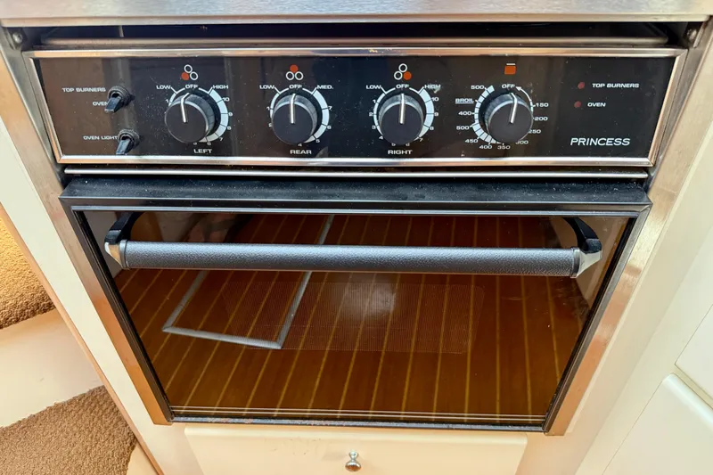 Slide: The Image of Oven controls on a 1997 Carver 355 Aft Cabin Motor Yacht, featuring Princess brand. - 25