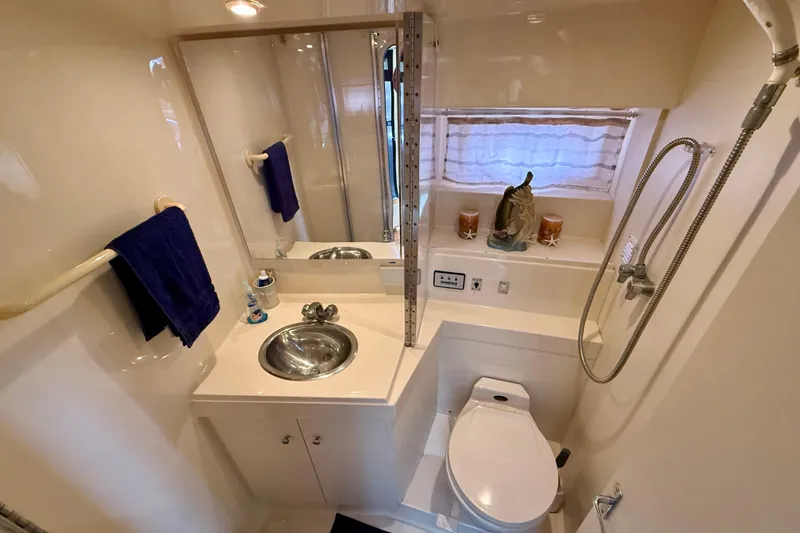 Slide: The Image of Bathroom of 1997 Carver 355 Aft Cabin Motor Yacht with sink, toilet, and shower. - 27