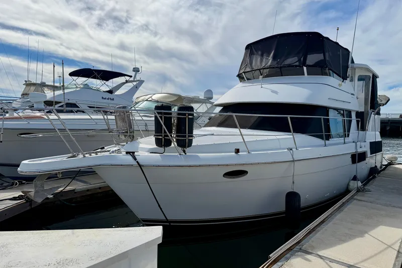Slide: The Image of 1997 Carver 355 Aft Cabin Motor Yacht docked at marina under cloudy sky. - 3