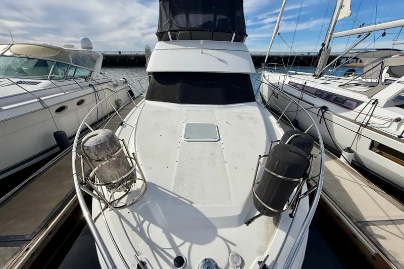 Slide: The Image of 1997 Carver 355 Aft Cabin Motor Yacht docked between two boats. - 8